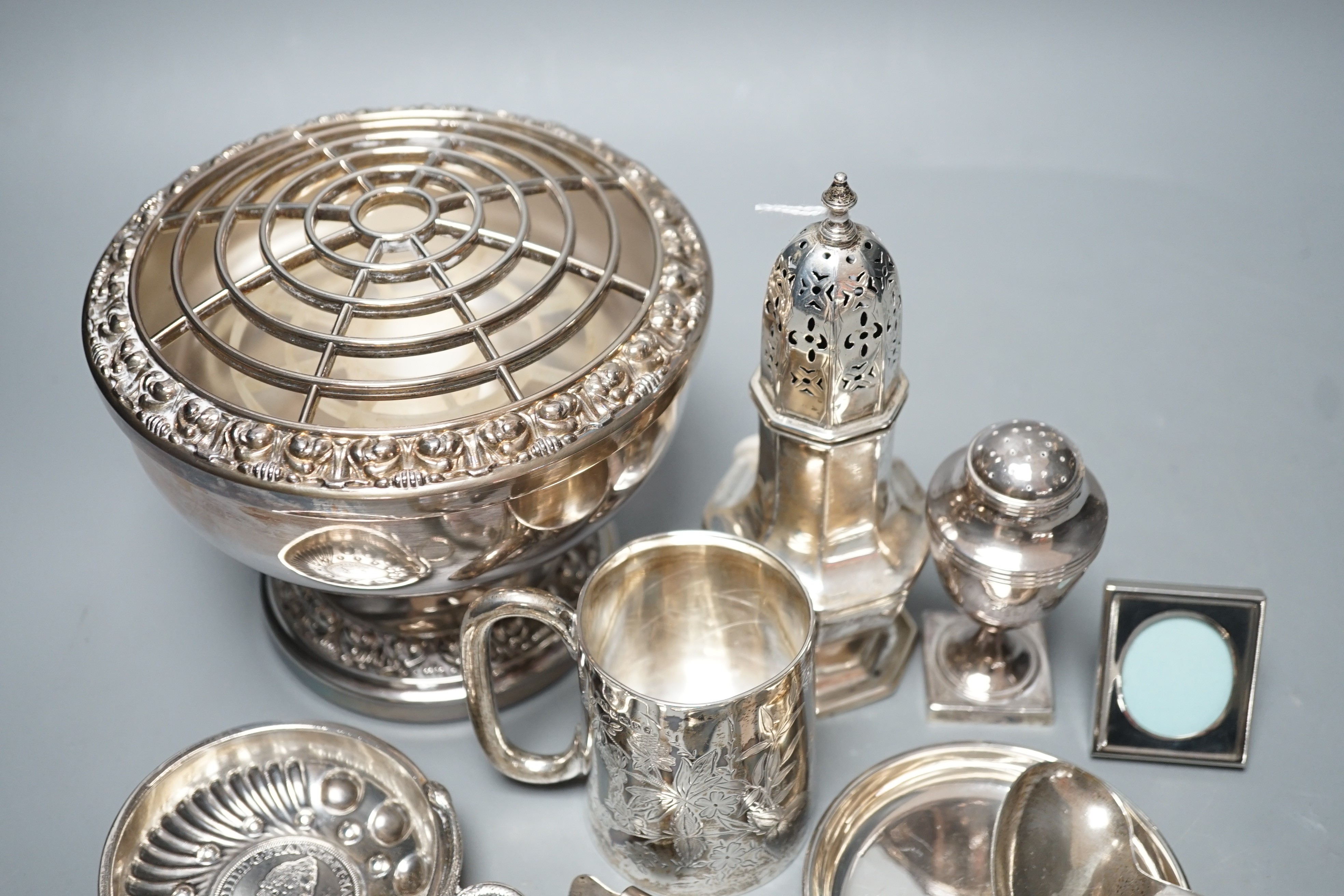 A George III silver vase shaped pepperette, Richard Evans? London, 1788, 88mm, a Victorian silver christening mug, a later silver sugar caster, a French white metal taste vin and other sundry silver and plated items.